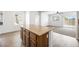 Bright kitchen boasts an island with a granite countertop, wood cabinets, and an open floor plan at 9146 Grand Sunburst Ct, Las Vegas, NV 89149
