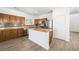 Well-lit kitchen with wood cabinets, stainless appliances, and an island with light countertops at 9146 Grand Sunburst Ct, Las Vegas, NV 89149