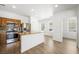 Bright kitchen featuring wood cabinets, stainless appliances, and a kitchen island with modern backsplash at 9146 Grand Sunburst Ct, Las Vegas, NV 89149