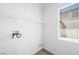 The laundry room features tile floors, washer and dryer hookups, and a wire shelf for storage at 9146 Grand Sunburst Ct, Las Vegas, NV 89149