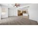 Open concept living room featuring carpet flooring, ceiling fan, and an open layout to the kitchen at 9146 Grand Sunburst Ct, Las Vegas, NV 89149