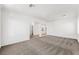 Spacious living room with neutral carpet and trim, arched entrance and bright, neutral paint at 9146 Grand Sunburst Ct, Las Vegas, NV 89149