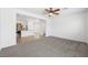 Open concept living room features carpet flooring and access to the kitchen at 9146 Grand Sunburst Ct, Las Vegas, NV 89149