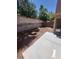Backyard featuring a concrete patio, gravel cover, and mature trees for shade and privacy at 9165 Beauchamp Ave, Las Vegas, NV 89148