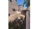 Spacious backyard featuring a retaining wall, gravel cover, and ample space for outdoor activities at 9165 Beauchamp Ave, Las Vegas, NV 89148