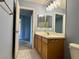 Bathroom with a single vanity, light fixtures, and blue paint at 9165 Beauchamp Ave, Las Vegas, NV 89148