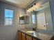 Bathroom featuring granite countertops, a modern vanity and a large mirror over the sink at 9165 Beauchamp Ave, Las Vegas, NV 89148