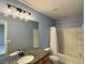 Bathroom featuring granite countertops, a modern vanity and a shower over the bath at 9165 Beauchamp Ave, Las Vegas, NV 89148