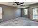 Bedroom with ceiling fan and door to balcony and dual windows at 9165 Beauchamp Ave, Las Vegas, NV 89148
