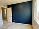 Bedroom featuring a dark accent wall and natural light from the exterior window at 9165 Beauchamp Ave, Las Vegas, NV 89148