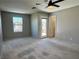 Spacious bedroom featuring a ceiling fan, with balcony access and dual windows at 9165 Beauchamp Ave, Las Vegas, NV 89148