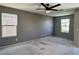 Spacious bedroom featuring a ceiling fan and windows, with neutral walls and carpet at 9165 Beauchamp Ave, Las Vegas, NV 89148