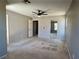 Spacious bedroom featuring a ceiling fan, dual windows, and access to other rooms at 9165 Beauchamp Ave, Las Vegas, NV 89148