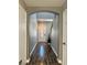Inviting entryway featuring wood-look flooring, neutral paint, and an arched opening to the living space at 9165 Beauchamp Ave, Las Vegas, NV 89148