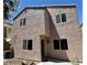 Two-story home with a neutral stucco exterior, windows, and a covered entry at 9165 Beauchamp Ave, Las Vegas, NV 89148