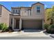 Two-story home featuring a balcony, stucco siding, and a two-car garage at 9165 Beauchamp Ave, Las Vegas, NV 89148