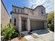 Two-story home featuring a balcony, stucco siding, and a two-car garage at 9165 Beauchamp Ave, Las Vegas, NV 89148