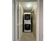A utility room featuring a stacked washer and dryer, offering convenience and space-saving design at 9165 Beauchamp Ave, Las Vegas, NV 89148