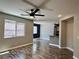 Inviting living room featuring wood floors, ceiling fan, and a bright window at 9165 Beauchamp Ave, Las Vegas, NV 89148