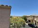A view from the balcony featuring lush greenery, mountains and neighboring houses and a blue sky at 9165 Beauchamp Ave, Las Vegas, NV 89148