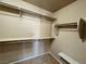 Spacious walk-in closet with a neutral color, featuring shelving and hanging rods, providing ample storage space at 9165 Beauchamp Ave, Las Vegas, NV 89148