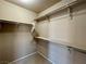Spacious walk-in closet featuring shelving and a hanging rod providing ample storage for clothes and accessories at 9165 Beauchamp Ave, Las Vegas, NV 89148