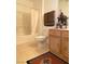 Well-lit bathroom featuring a tub with a shower, decorative towels, and a neutral color scheme at 9470 Peace Way # 212, Las Vegas, NV 89147