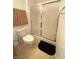 Bathroom featuring a sliding glass door on the shower, a white toilet, and a black bathmat at 9470 Peace Way # 212, Las Vegas, NV 89147