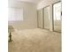 Large bedroom with mirrored closet doors, window for natural light, and neutral colored walls at 9470 Peace Way # 212, Las Vegas, NV 89147