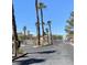 View of the community entrance with palm trees; access controlled via secure gate at 9470 Peace Way # 212, Las Vegas, NV 89147