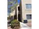 Close-up of the building exterior, showcasing the walkways, stairs, and landscaping at 9470 Peace Way # 212, Las Vegas, NV 89147