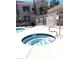 Community hot tub adjacent to a pool, surrounded by a secure metal fence at 9470 Peace Way # 212, Las Vegas, NV 89147