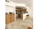 Open-concept view of the kitchen with breakfast bar, wooden cabinets, and modern appliances at 9470 Peace Way # 212, Las Vegas, NV 89147
