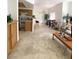 Spacious living room with neutral carpet, breakfast bar, and dining area bathed in natural light at 9470 Peace Way # 212, Las Vegas, NV 89147
