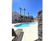 Community pool area surrounded by palm trees and multi-story residential buildings at 9470 Peace Way # 212, Las Vegas, NV 89147