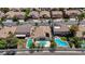 An aerial view shows multiple single-Gathering homes, a street with parked cars and mature trees at 9632 Cherry Canyon Ave, Las Vegas, NV 89129