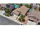 Aerial view of a residence with a well-manicured front yard, palm trees, and a three car garage at 9632 Cherry Canyon Ave, Las Vegas, NV 89129