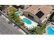 A backyard with a geometrically shaped pool, greenery, and solar panels on the roof at 9632 Cherry Canyon Ave, Las Vegas, NV 89129