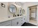 Modern bathroom featuring double sinks, round mirrors, and black hardware at 9632 Cherry Canyon Ave, Las Vegas, NV 89129