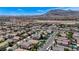 This aerial shot captures a vast residential area against a backdrop of scenic mountains and blue sky at 9632 Cherry Canyon Ave, Las Vegas, NV 89129