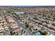 This aerial shot showcases a vast community with manicured streets, pools, and houses at 9632 Cherry Canyon Ave, Las Vegas, NV 89129