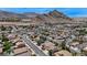This aerial shot reveals a residential neighborhood with a picturesque mountain range in the background at 9632 Cherry Canyon Ave, Las Vegas, NV 89129