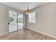 Bright dining area featuring modern light fixture, wood flooring, and sliding glass doors leading to the patio at 9632 Cherry Canyon Ave, Las Vegas, NV 89129