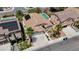 Aerial view showcases this home with a manicured lawn, mature trees, and a wide driveway, nestled in a community at 9632 Cherry Canyon Ave, Las Vegas, NV 89129
