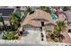Home featuring a well-kept lawn, mature landscaping, and a spacious driveway leading to a three car garage at 9632 Cherry Canyon Ave, Las Vegas, NV 89129
