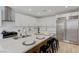 Well-appointed kitchen with stainless steel appliances, white cabinets, and bar stool seating at 9632 Cherry Canyon Ave, Las Vegas, NV 89129