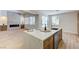 Stylish kitchen with island, stainless steel appliances, and view into adjoining living area at 9632 Cherry Canyon Ave, Las Vegas, NV 89129