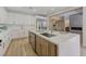Open kitchen layout featuring white cabinets, stainless steel appliances, and island with sink at 9632 Cherry Canyon Ave, Las Vegas, NV 89129