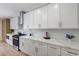 Bright kitchen featuring white cabinetry, stone countertops, stainless steel range, and modern hardware at 9632 Cherry Canyon Ave, Las Vegas, NV 89129