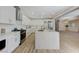 Bright kitchen featuring white cabinetry, stainless steel appliances, and an island with stone countertop at 9632 Cherry Canyon Ave, Las Vegas, NV 89129